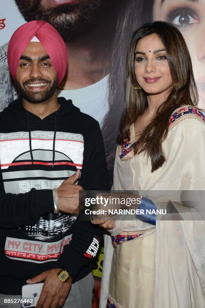 Indian Punjabi actors Ammy Virk and actress Monica Gill pose during a promotional event for the upcoming Punjabi film 'Sat Shri Akaal England' at an...