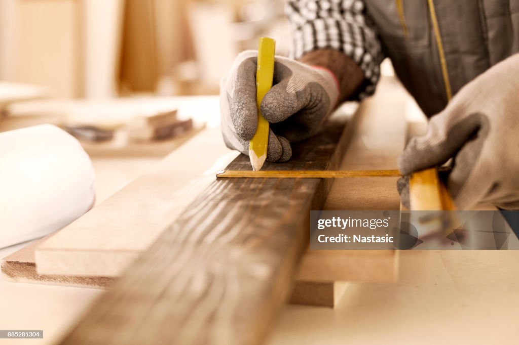 Carpenter taking perfect measurement