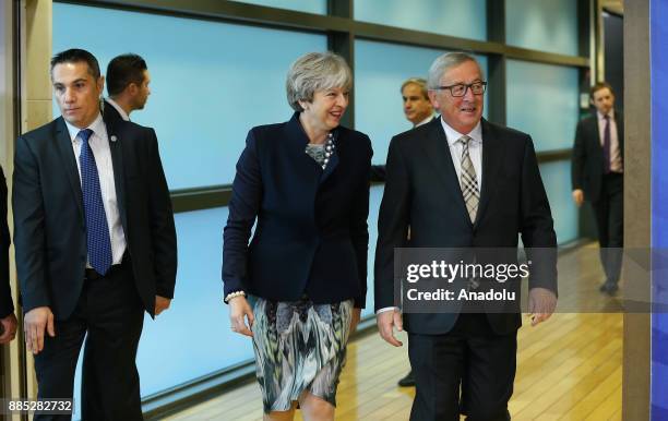 British Prime Minister Theresa May and European Commission Chief Jean-Claude Juncker walk during their meeting prior to a Brexit negotiation meeting...