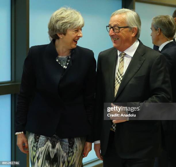 British Prime Minister Theresa May and European Commission Chief Jean-Claude Juncker walk during their meeting prior to a Brexit negotiation meeting...