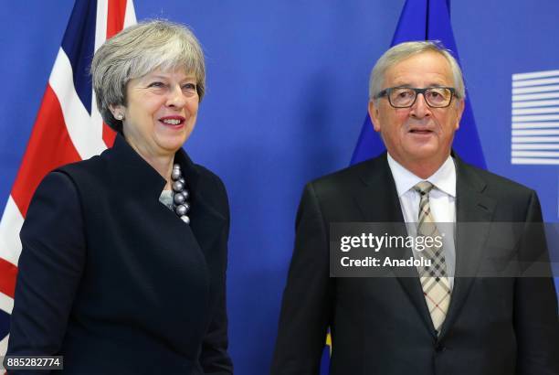 British Prime Minister Theresa May and European Commission Chief Jean-Claude Juncker pose prior to a Brexit negotiation meeting on December 4, 2017...