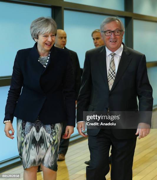 British Prime Minister Theresa May and European Commission Chief Jean-Claude Juncker walk during their meeting prior to a Brexit negotiation meeting...