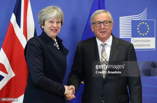 British Prime Minister Theresa May and European Commission Chief Jean-Claude Juncker shake hands as they pose prior to a Brexit negotiation meeting...