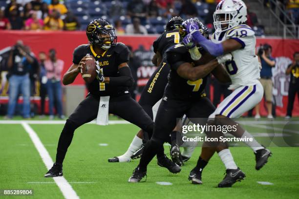 Grambling State Tigers quarterback Devante Kincade looks to throw downfield during the SWAC Championship football game between the Alcorn State...