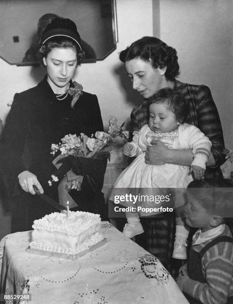 Princess Margaret cuts the cake at Sharon Shipman's first birthday party, during a visit to the Shipman family home at 25 Amwell Court, Stoke...