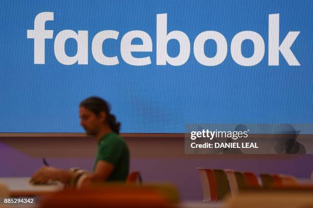 Employee eats lunch in the canteen at Facebook's new headquarters, designed by Canadian-born American architect Frank Gehry, at Rathbone Place in...