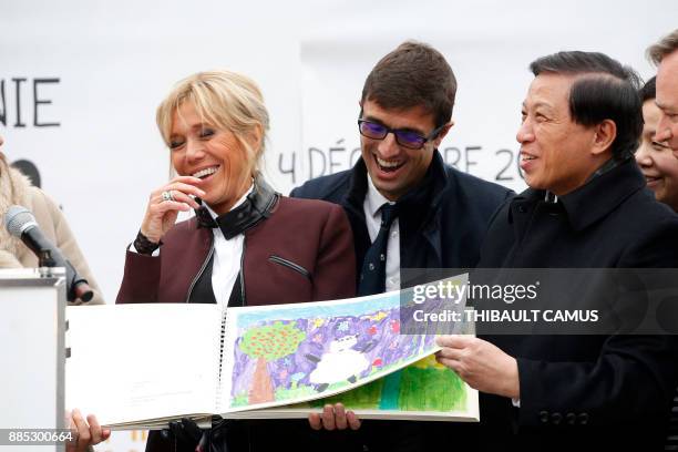 French president's wife Brigitte Macron, Director of the Beauval Zoo, Rodolphe Delord and China's vice foreign minister Zhang Yesui react as they...