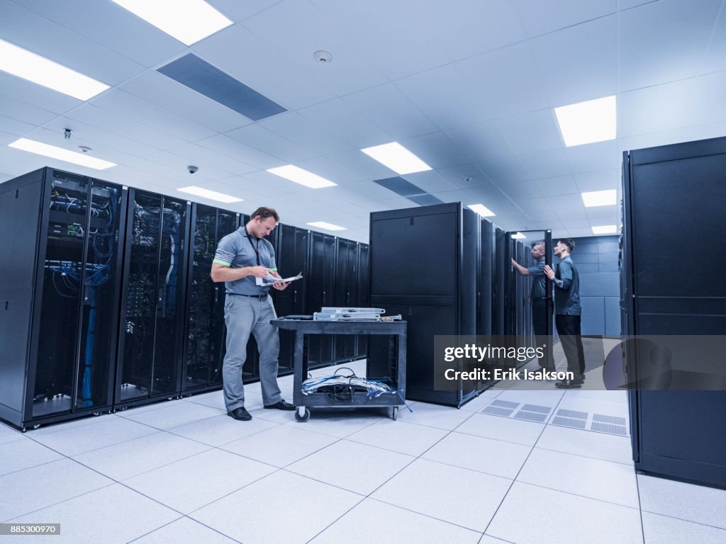 Men working in server room