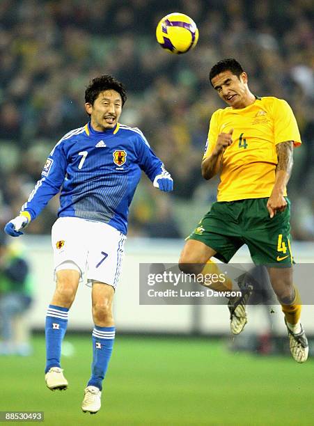 Tim Cahill of Australia heads the ball against Hideo Hashimoto of Japan during the 2010 FIFA World Cup Asian qualifying match between the Australian...