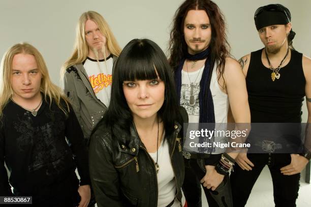 Posed studio group portrait of Finnish metal band Nightwish. Left to right are Emppu Vuorinen, Marco Hietala, Anette Olzon, Tuomas Holopainen and...