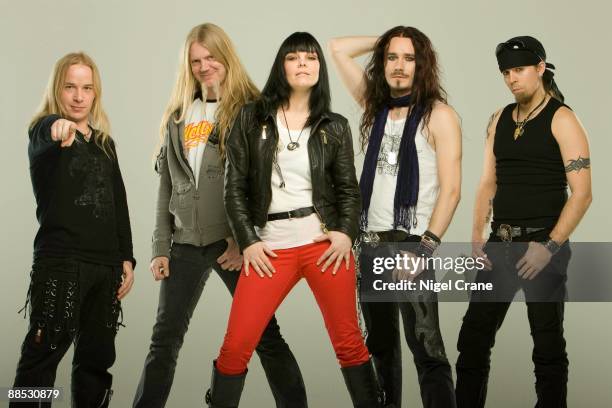 Posed studio group portrait of Finnish metal band Nightwish. Left to right are Emppu Vuorinen, Marco Hietala, Anette Olzon, Tuomas Holopainen and...