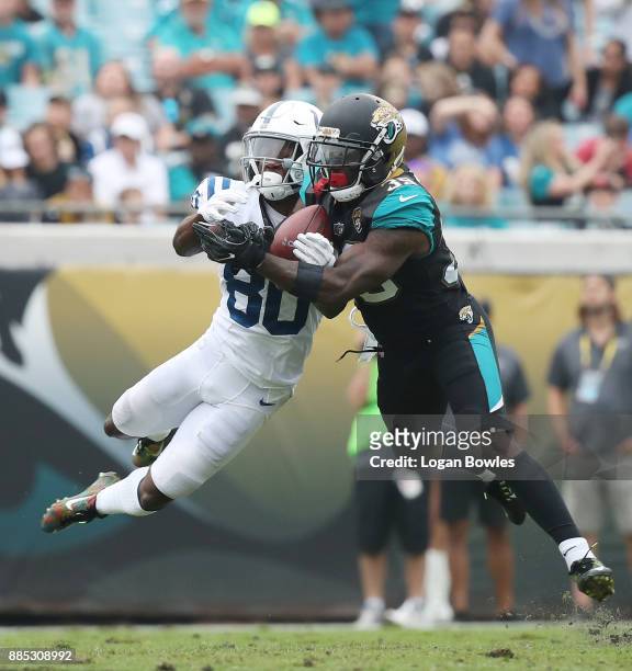 Tashaun Gipson of the Jacksonville Jaguars picks off the football in front of Chester Rogers of the Indianapolis Colts in the second half of their...