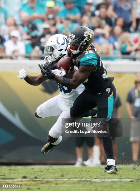 Tashaun Gipson of the Jacksonville Jaguars picks off the football in front of Chester Rogers of the Indianapolis Colts in the second half of their...