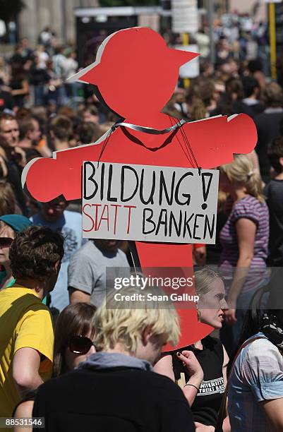 Young woman holds a sign that reads: "Education! Instead of Banks" among striking students protesting in front of Humboldt University on June 17,...