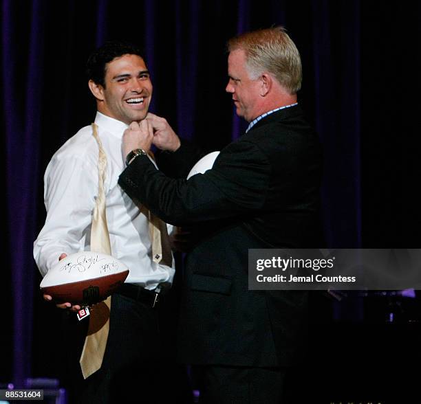 Mark Sanchez, Quarterback for the New York Jets and Boomer Esiason former NFL Quarterback prepare to throw out an autographed football for charity...