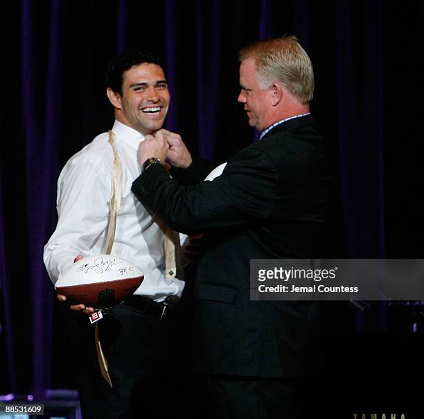Mark Sanchez, Quarterback for the New York Jets and Boomer Esiason former NFL Quarterback prepare to throw out an autographed football for charity...