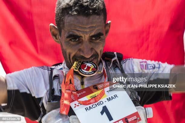 Morrocan trail runner Rachid El Morabity crosses the finish line to win the first edition of the Marathon des Sables Peru in Paracas on December 4 in...