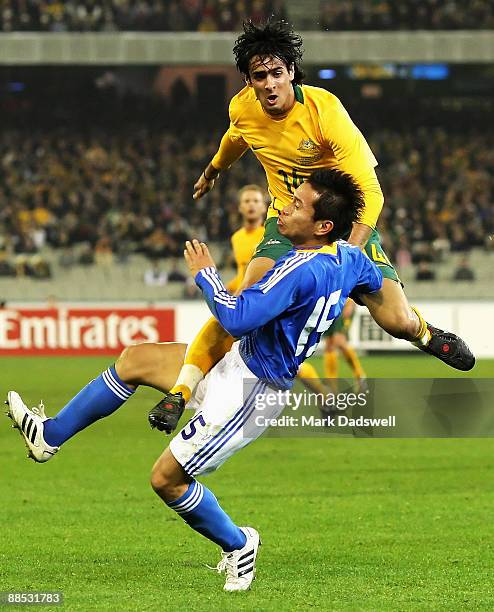 Rhys Williams of the Socceroos collides with Yuto Nagatomo of Japan during the 2010 FIFA World Cup Asian qualifying match between the Australian...