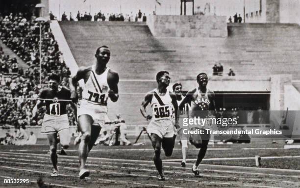 American athlete and Olympic gold medal winner Jesse Owens easily leads the pack in the semi-final heat of the Men's 100m event at the Olympic Games,...
