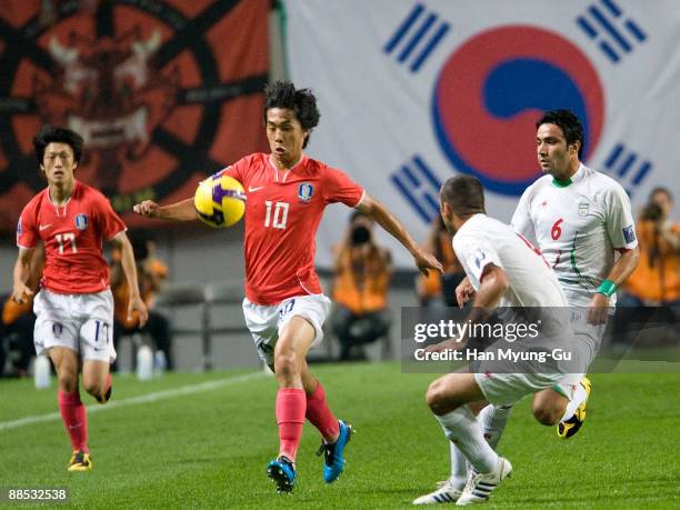 Park Chu-Young of South Korea is challenged by Nekounam Javad of Iran during the 2010 FIFA World Cup Asian Qualifiers match between Iran and South...