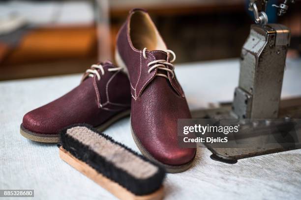 beautiful custom made leather shoes next to sewing machine. - leather boot stock pictures, royalty-free photos & images