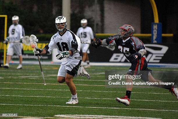 Stephen Peyser of the Long Island Lizards controls the ball during a Major League Lacrosse game as Sean Morris of the Boston Cannons tries to defend...