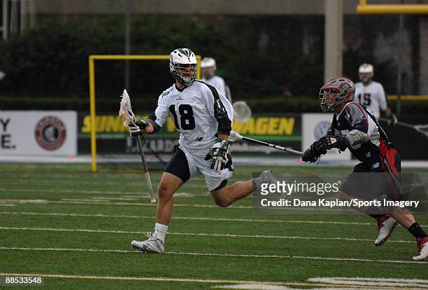 Stephen Peyser of the Long Island Lizards controls the ball during a Major League Lacrosse game as Sean Morris of the Boston Cannons tries to defend...
