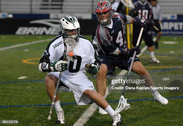 Matt Danowski of the Long Island Lizards controls the ball during a Major League Lacrosse game as Chris Passavia of the Boston Cannons tries to...