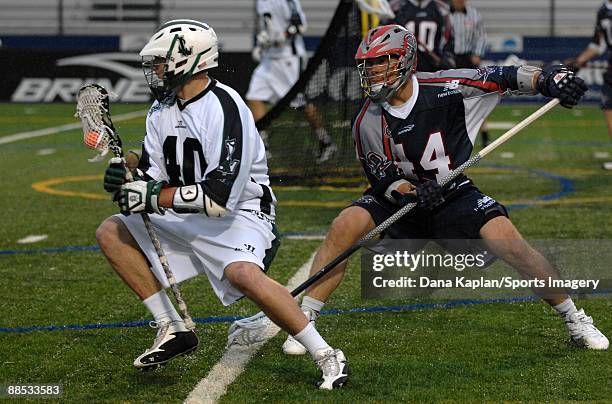 Matt Danowski of the Long Island Lizards controls the ball during a Major League Lacrosse game as Chris Passavia of the Boston Cannons tries to...