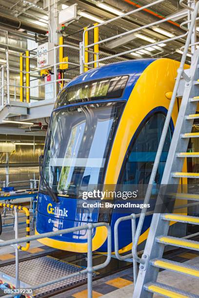 front view gold coast light rail tram being serviced in depot - gold coast light rail stock pictures, royalty-free photos & images