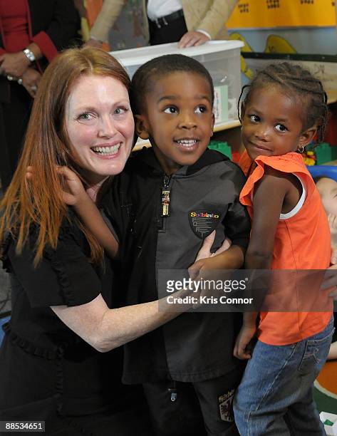 Julianne Moore, Artist Ambassador for Save the Children's U.S. Programs, hugs two school children after the "Disaster Decade: Lessons Unlearned For...