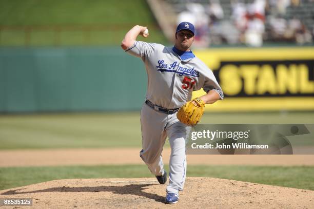 Jonathan Broxton of the Los Angeles Dodgers pitches during the game against the Texas Rangers at Rangers Ballpark in Arlington in Arlington, Texas on...