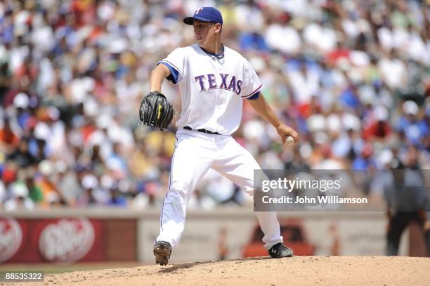 Derek Holland of the Texas Rangers pitches during the game against the Los Angeles Dodgers at Rangers Ballpark in Arlington in Arlington, Texas on...