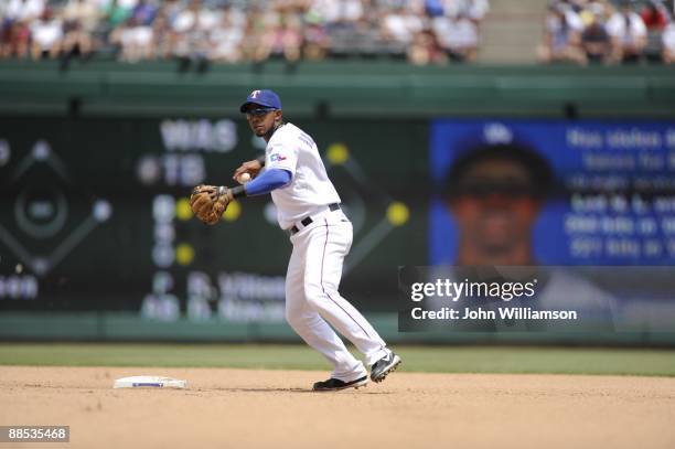 Shortstop Elvis Andrus of the Texas Rangers fields his position as he throws to first base after catching a ground ball during the game against the...