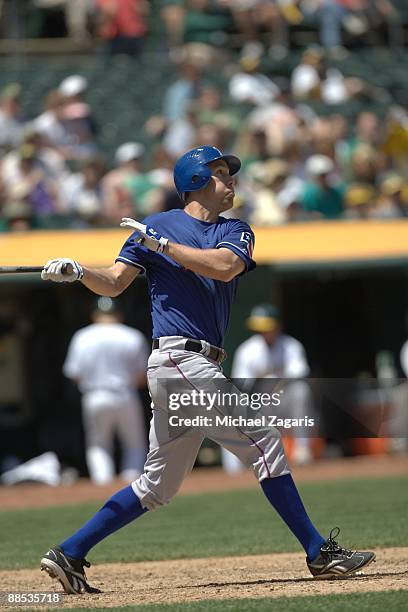 David Murphy of the Texas Rangers swings at a pitch during the game against the Oakland Athletics at the Oakland Coliseum on May 7, 2009 in Oakland,...