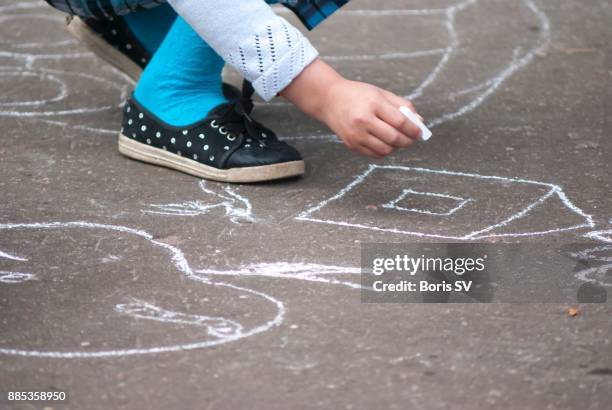 girl drawing house on asphalt with chalk - 9 hand drawn patterns stock pictures, royalty-free photos & images