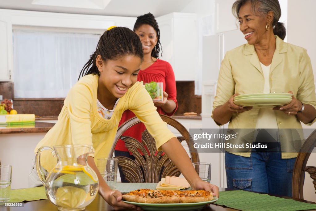 African family eating dinner in kitchen