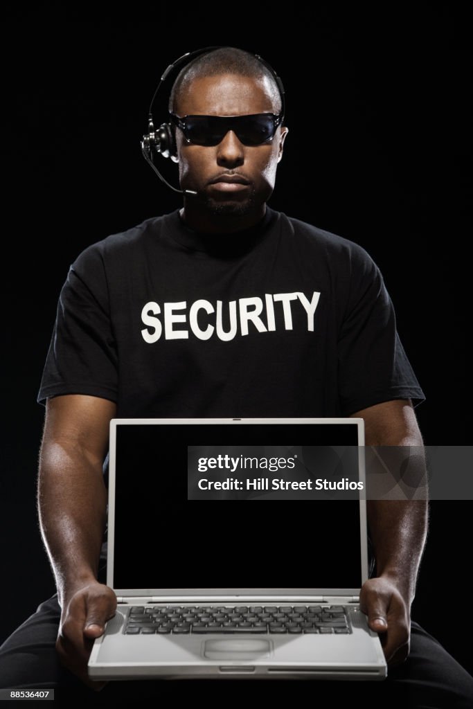 African security guard with laptop