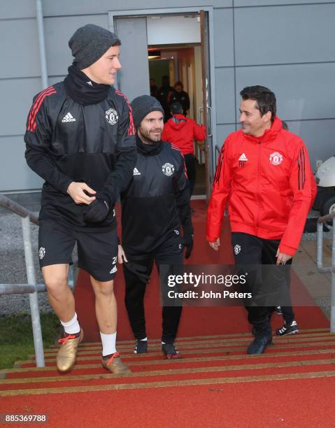 Ander Herrera, Juan Mata and Assistant Manager Rui Faria of Manchester United walk out ahead of a first team training session at Aon Training Complex...