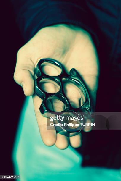 france, young man with brass knuckles - knuckle duster imagens e fotografias de stock