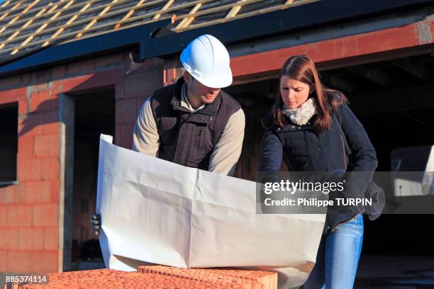 france, young architect and customer in a house in construction. - general director stock pictures, royalty-free photos & images