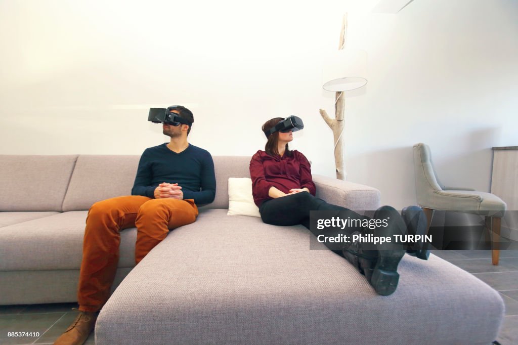 Young couple at home using virtual mask