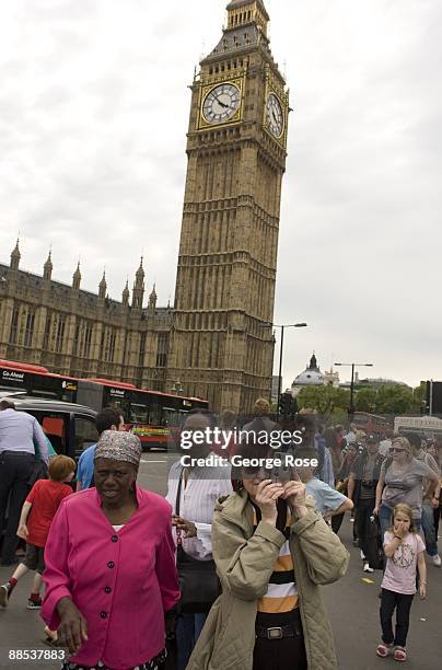 Tourist take a picture of the Thames River with Big Ben clocktower and the House of Parliament in the background as seen in this 2009 London, United...