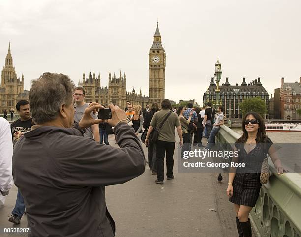 Tourist take a picture of the Thames River with Big Ben clocktower and the House of Parliament in the background as seen in this 2009 London, United...