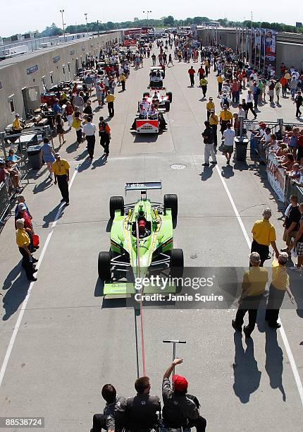 The i drive green HVM Racing Dallara Honda is led to pit lane during Miller Lite Carb Day practice for the IRL IndyCar Series 93rd running of the...