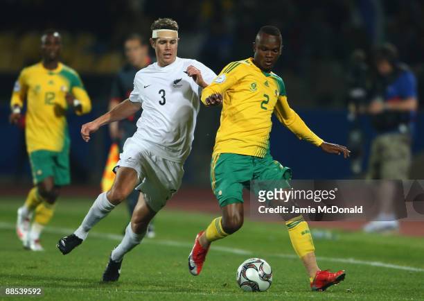 Tony Lochhead of New Zealand battles with Siboniso Gaxa of South Africa during the FIFA Confederations Cup match between South Africa and New Zealand...