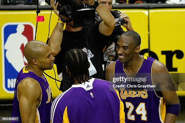 Derek Fisher, Josh Powell and Kobe Bryant of the Los Angeles Lakers smile during the final moments of the Lakers' win over the Orlando Magic in Game...