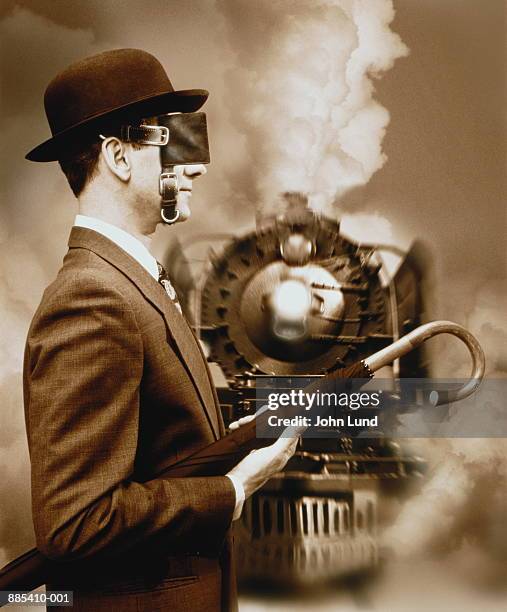 blinkered businessman on railway, train approaching (composite) - blinder stock pictures, royalty-free photos & images