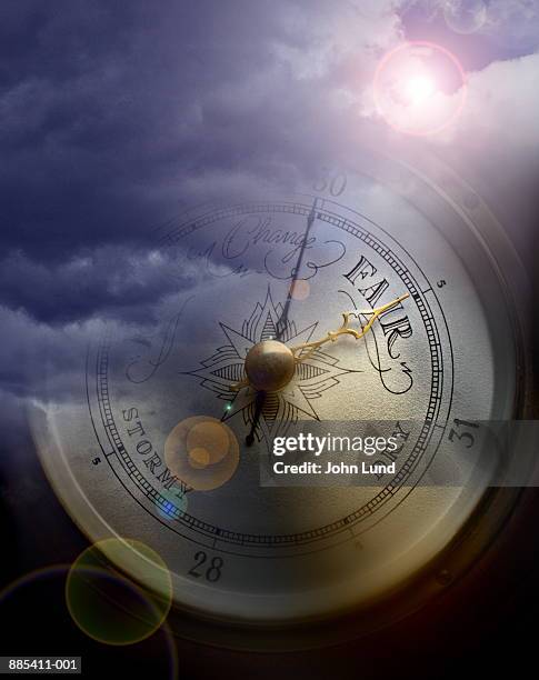 barometer superimposed over storm clouds (digital composite) - barometer stock-fotos und bilder