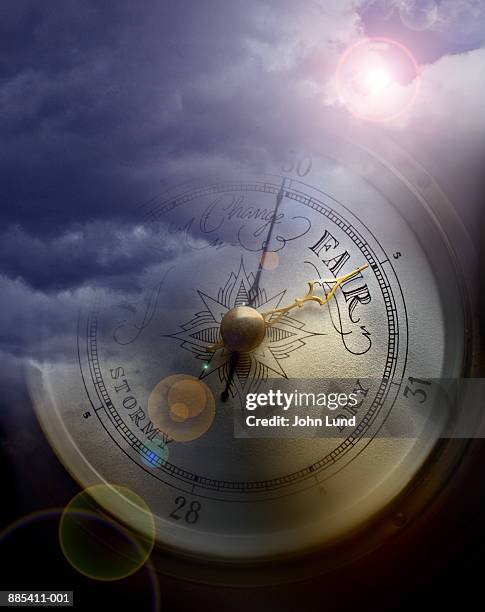 barometer superimposed over storm clouds (digital composite) - a picture of a barometer foto e immagini stock